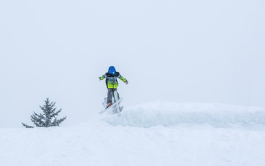 People are having fun in downhill skiing and snowboarding in the middle of snowfall 