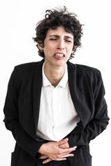 Upset businesswoman suffering from pain. Unhappy middle aged businesswoman with short hair suffering from ache in stomach isolated on white background. Medicine concept