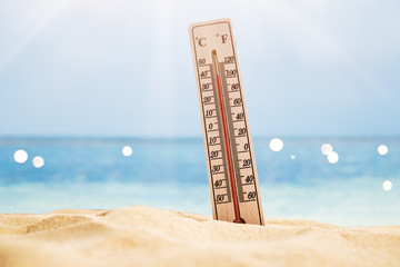 Thermometer On Sand Showing High Temperature