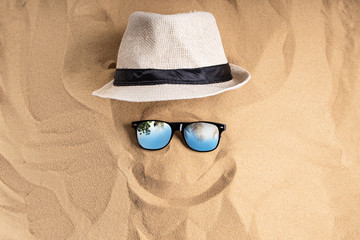 Sunglasses And Hat On Sand At Beach