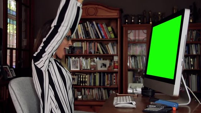 Business Woman Working at the Office with a Computer Green Screen and Receiving Good News. You can replace green screen with the footage or picture you want. You can do it with “Keying” effect in AE.