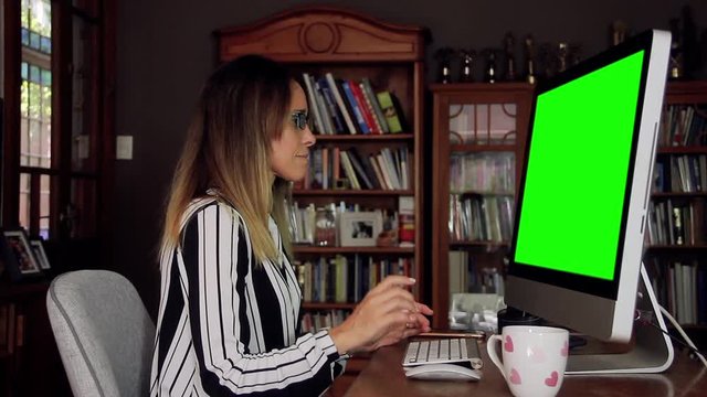Business Woman Working at the Office with a Computer Green Screen and Receiving Good News. You can replace green screen with the footage or picture you want. You can do it with “Keying” effect in AE.