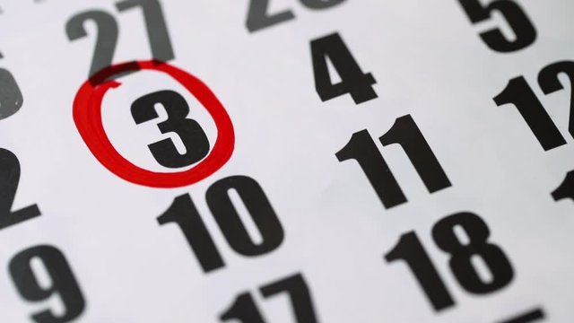 Mark the 3rd number on the calendar with a red marker. A black number 3 is circled in a red circle. Close-up, top view.