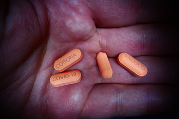 COVID-19 CORONA virus caption on pill cure medicine
