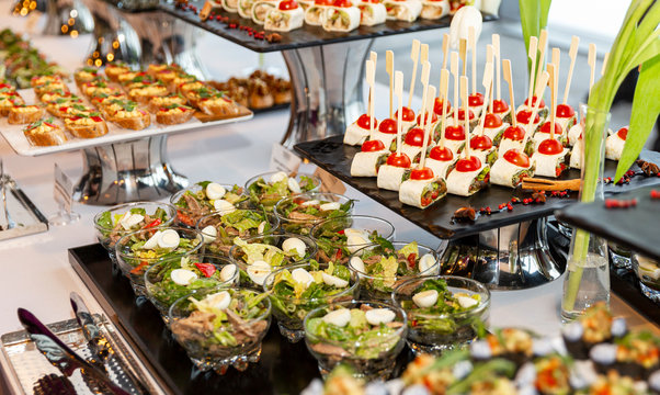 Appetizing snacks on the buffet table at the event. Close-up.