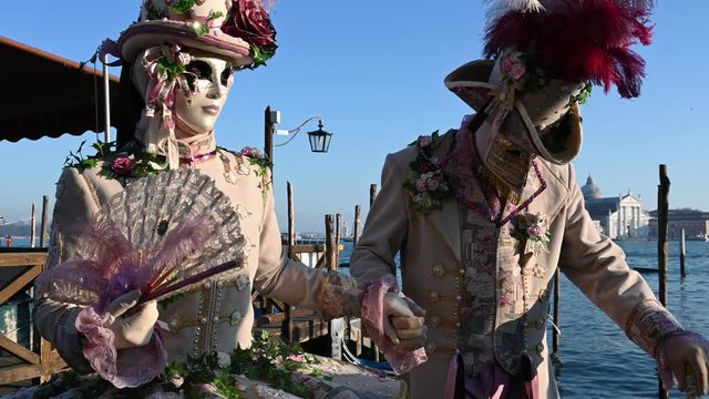 February 2020 Venice Carnival, Italy - carnival masks are photographed with tourists in Piazza San Marco