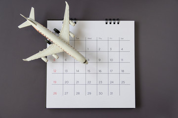 Airplane model with paper calendar. plan for trip