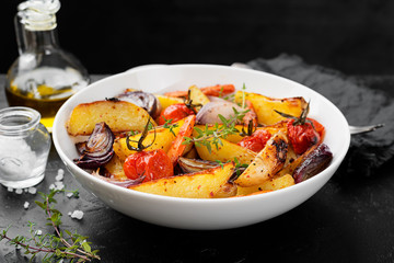 Roasted vegetables in a white plate. Vegetarian dish.