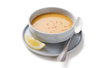 Red lentil soup served with lemon and toasted bread. isolated on white background
