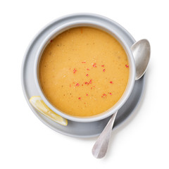 Red lentil soup served with lemon and toasted bread. isolated on white background