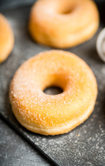 Donut with apple jam on the rustic background. Selective focus.