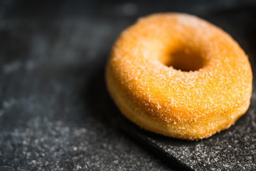 Donut with apple jam on the rustic background. Selective focus.