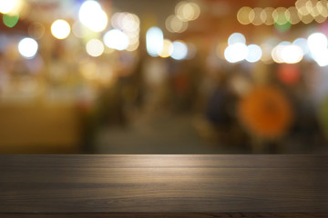 Empty dark wooden table in front of abstract blurred bokeh background of restaurant . can be used for display or montage your products.Mock up for space.