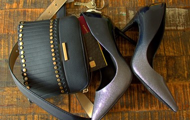 handbag with a fringe, high-heeled shoes and a credit card with a foreign passport