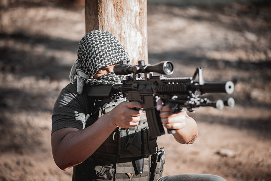 Man terrorist wearing a mask and holding a gun, Terrorist concpet
