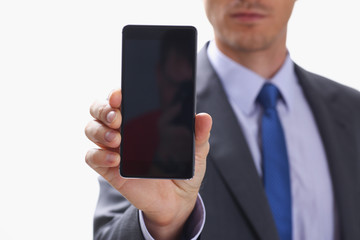 A businessman holding smartphone in hand demonstrates display on which calculator is depicted with figure of zero. The accountant has calculated all transactions are correct debt has credit approx ok