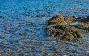 nature stone shore line scenic view with rocks and blue water wavy surface simple outside background