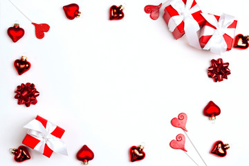 Frame of gift boxes and hearts on white background.