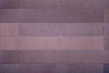 rusted and screwed in metal iron planks on a wall