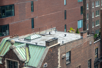 top view of new york city Manhattan sliver rooftop skylight windows classic brick buildings