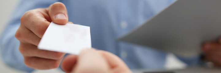 Male hand in suit give blank calling card tom man visitor closeup. White collar partners company name exchange executive or ceo introducing at conference product consultant sale clerk concept
