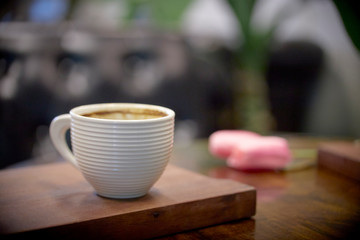 Cup of fresh coffee on wooden background