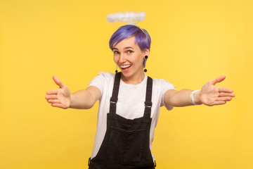 Portrait of friendly cute hipster girl with angelic halo above violet short hair and in denim...