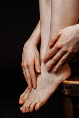 Female hands stroking naked female feet