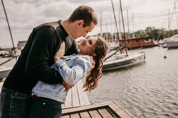 Young beautiful couple walking along the waterfront / Lifestyle