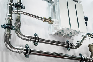 wiring of radiator pipes in the room on the wall. Example of pipe wiring