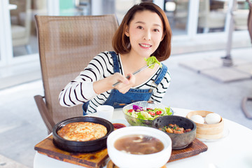 Happy woman eating out in a restaurant stock photo