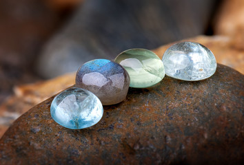 Round cut quartz and emerald mineral gemstones.