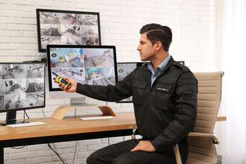 Male security guard with portable transmitter at workplace