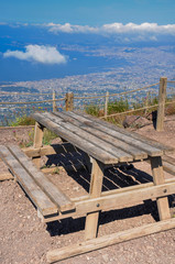 Fototapeta premium Empty wooden bench on mountain Vesuvio with view on Naples in sunny day