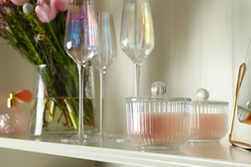White shelving unit with glassware and different decorative elements