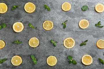 Lemonade layout with juicy lemon slices and mint on grey table, top view