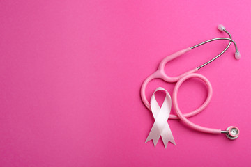 Obraz na płótnie Canvas Pink ribbon and stethoscope on color background, flat lay with space for text. Breast cancer concept