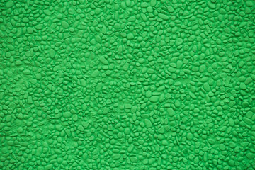 Fototapeta premium wall of small stones painted light green