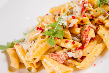 Penne with meat sauce decorated on a plate