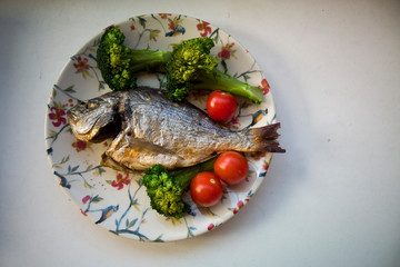 gilt-head bream fish grilled with tomato and broccoli