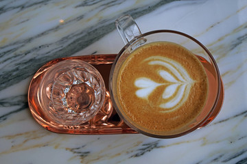 Hot Latte coffee in white cup on wood  table at coffee cafe