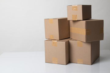 Pile of various size taped up  cardboard boxes