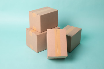 Pile of four taped up  cardboard boxes