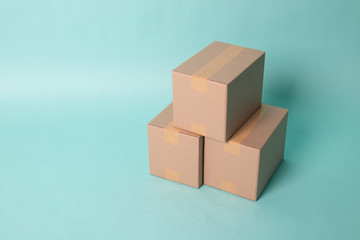 Pile of three  taped up  cardboard boxes