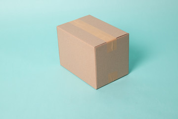 Closed cardboard box taped up ready to delivery