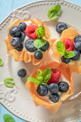 Delicious phyllo cups with fresh berries and whipped cream