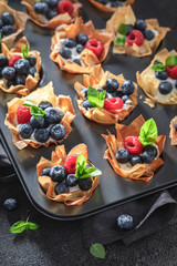 Fresh phyllo cups with blueberries, raspberries and whipped cream