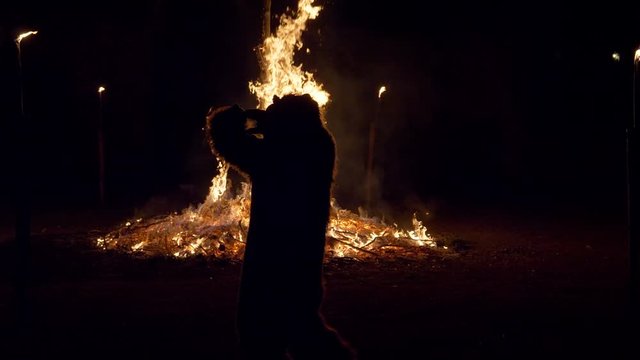 A bear dancing near a bonfire during &ldquo;Giubiana&rdquo; (a traditional celebration in the northern Italian on which a puppet of an old witch is burnt) - 30 January 2020, Canzo (Italy)