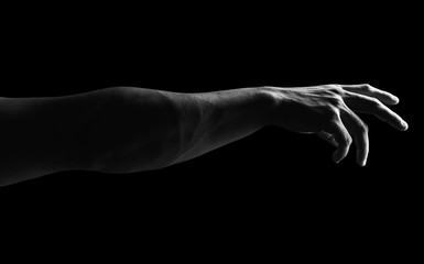 Fototapeta na wymiar Detail of muscular man arm against a black background