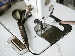 closeup sewing machine head parts needle holder.